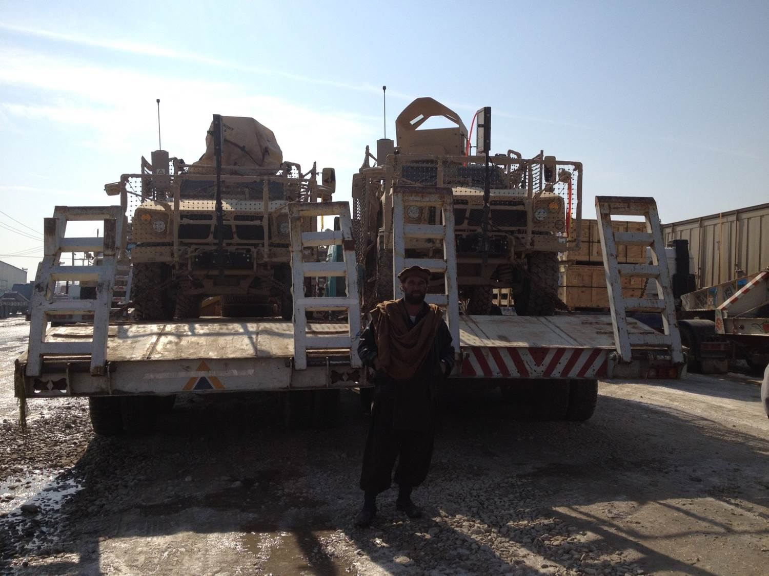 Armored vehicles loaded on lowbed trailers for movement between sites