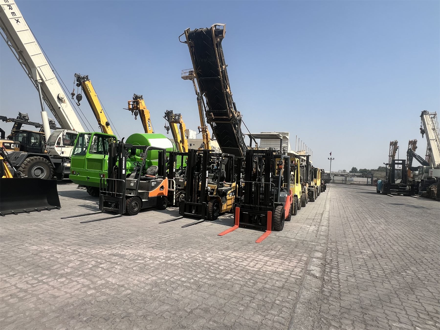 Forklift and crane operations in a heavy-equipment yard