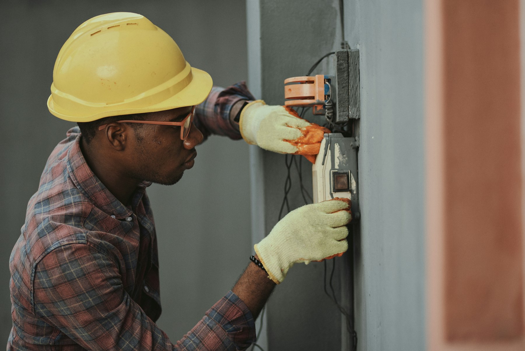 Electrician testing and servicing power distribution equipment